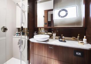 s62-interior-owners-stateroom-bathroom-walnut-satin.jpg