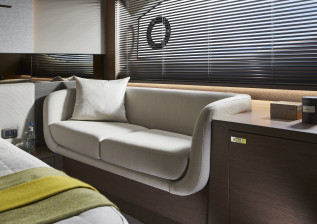 v55-interior-owners-stateroom-sofa-silver-oak-satin.jpg