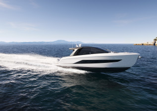 c48-deck-saloon-exterior-white-hull-with-outboards-running.jpg